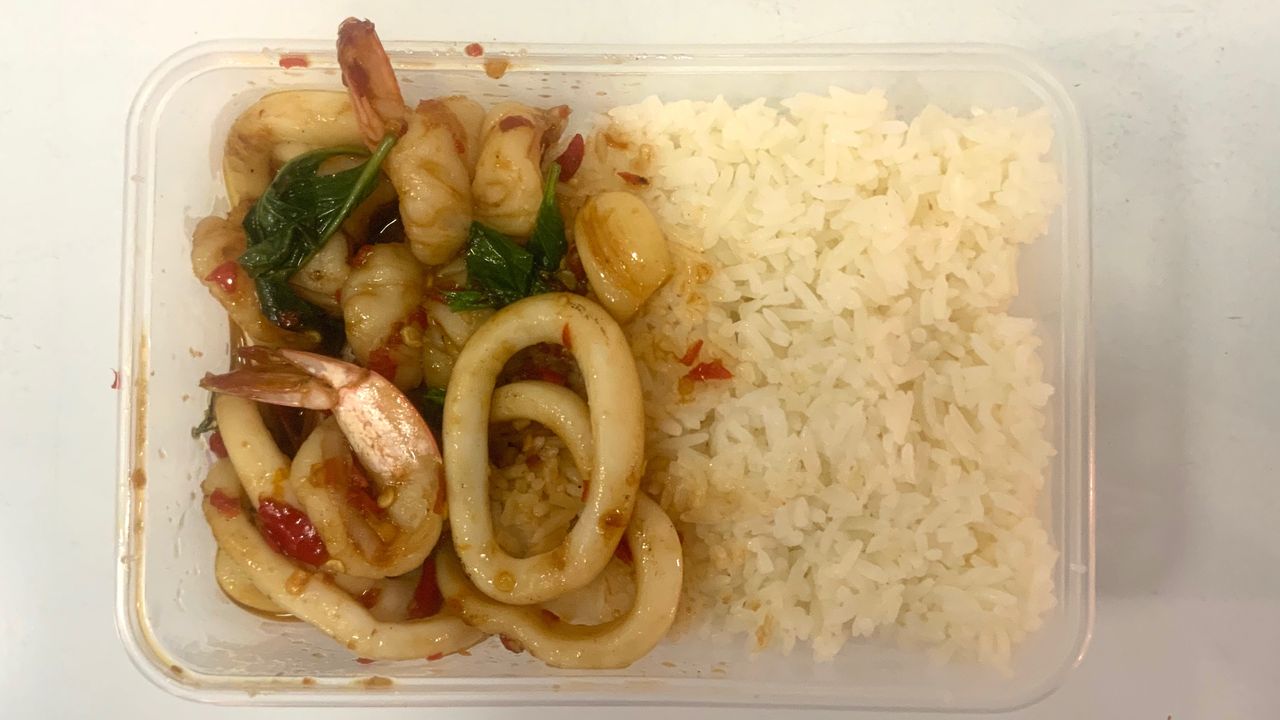 Basil stir fry with prawns and calamari  กะเพรากุ้งปลาหมึกราดข้าว