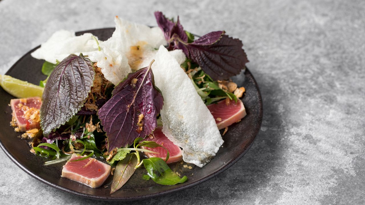 Seared Tuna, Green Papaya, Fresh Herbs, Perilla, Crispy Bits, Peanut + Lime Dressing