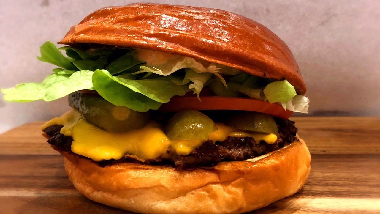 American Classic Burger with chips and a drink.