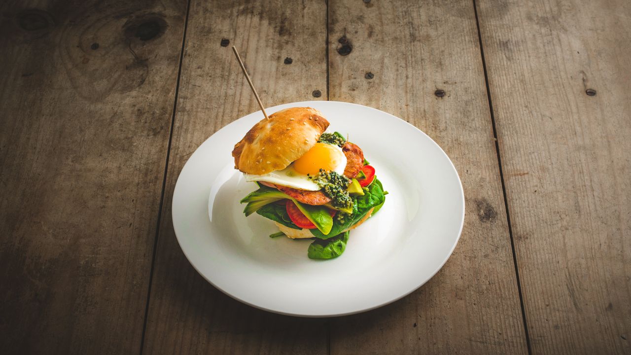 Breaky Beach Burger with Bacon, Egg, Fresh Tomato, Baby Spinach, Avocado and Pesto (GFO)