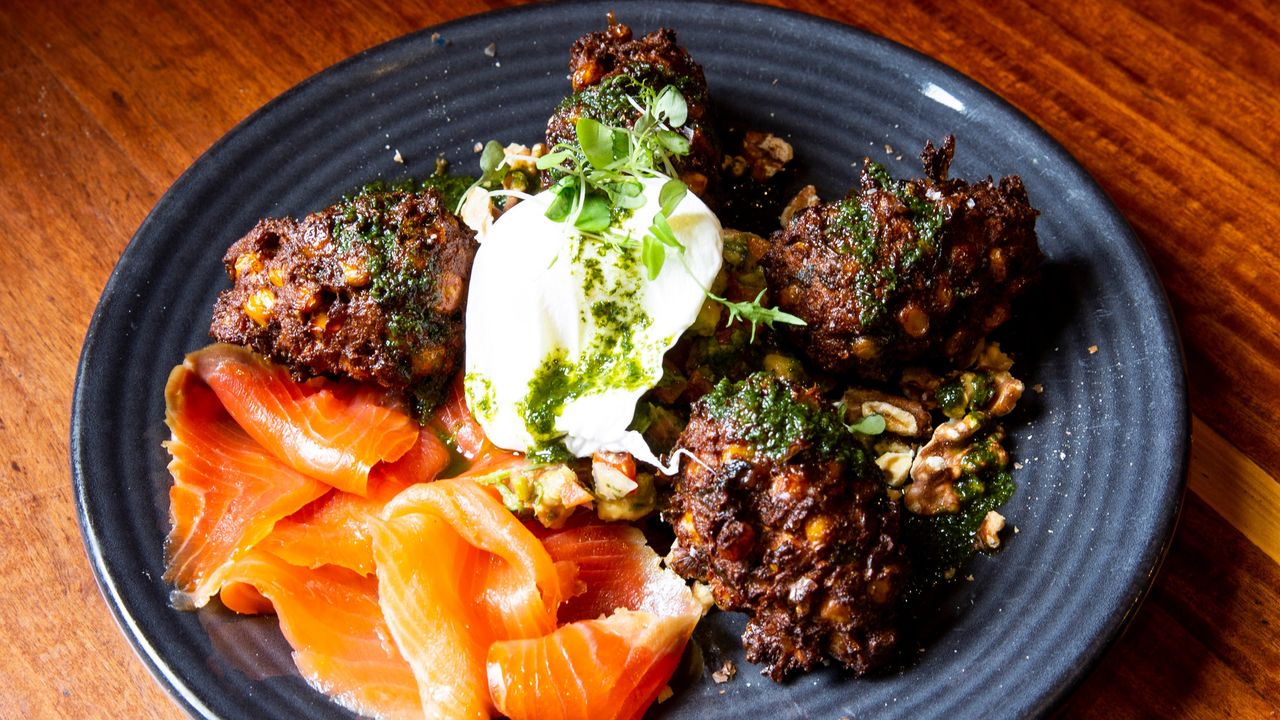 Corn Fritters with Avocado, Tomato, Onion & Coriander Salsa, Walnut Crumbs, Basil Oil & a Poached Egg